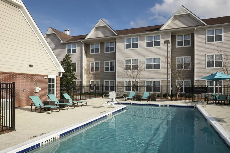 The outdoor pool with sky-blue loungers at the Residence Inn by Marriott Dothan