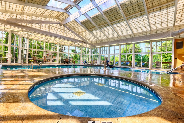 Two indoor pools at RiverStone Resort and Spa, surrounded by lots of windows