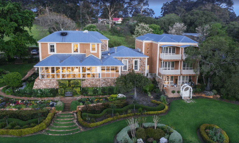 An overhead view of the back of the granite-adorned Grand Mercure Basildene Manor, with beautiful landscaped gardens
