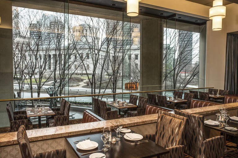 Elegant dining hall at the Sheraton Columbus Hotel at Capitol Square, with high ceilings and large windows