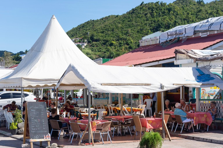 Several diners eat under a canopy outside Chez Coco