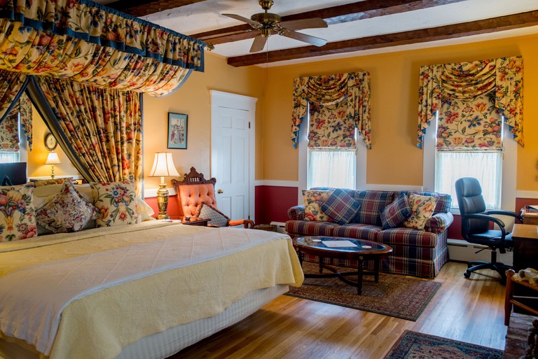 The king suite with floral textiles at the Beaconlight Guest House