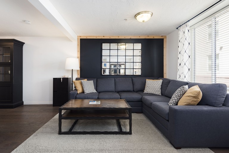 Modern chic sofa area with interior window at The Kimball at Temple Square