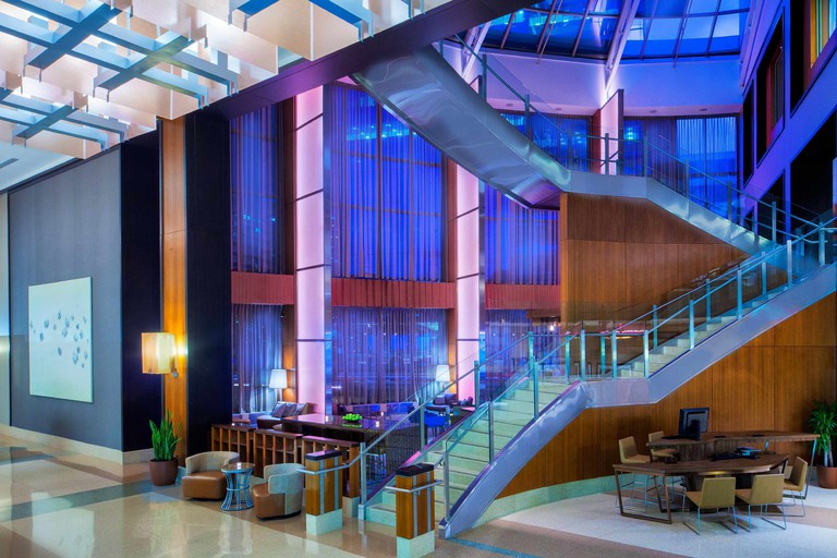 Inside view of the Westin Jersey City Newport with a large staircase and lounge area