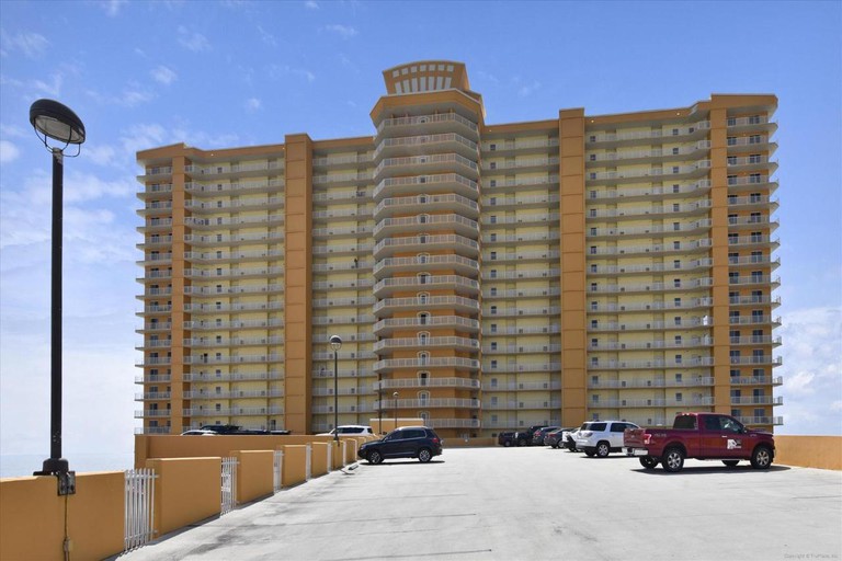 The exterior of the multilevel Treasure Island Resort with balconies