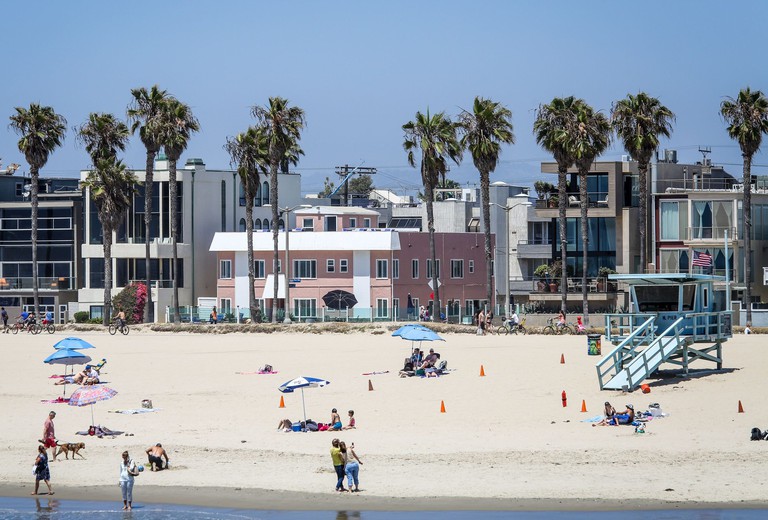 View of Venice on the Beach Hotel on the Venice Boardwalk from the water with people taking selfies