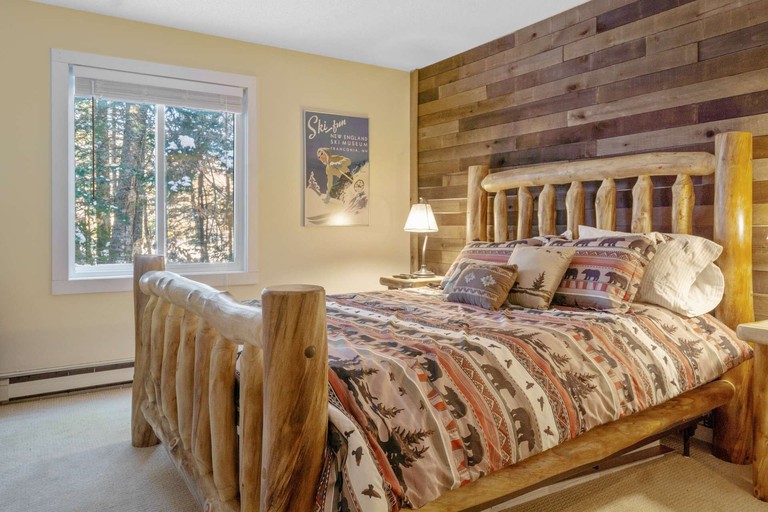 The Danbury room with wooden bed and vintage ski artwork