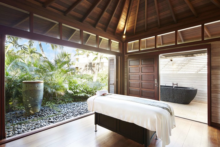 A massage table in an open-air spa room at Montage Kapalua Bay