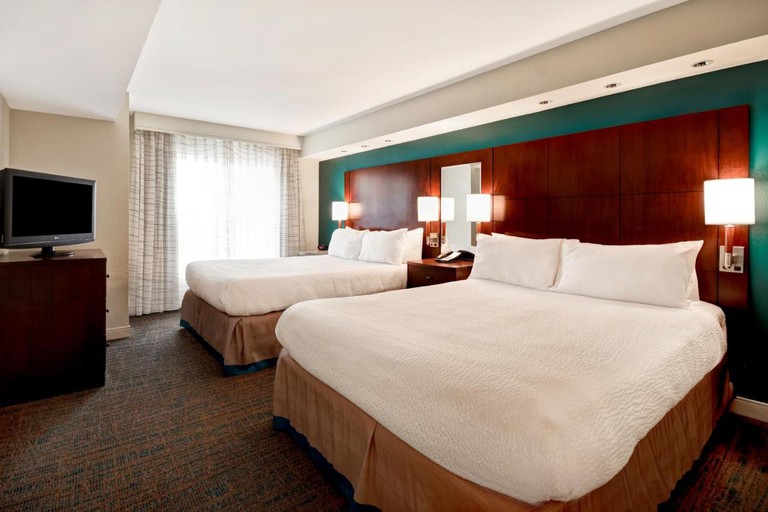 Residence Inn by Marriott Stillwater room with flatscreen and headboard, bedside lamps