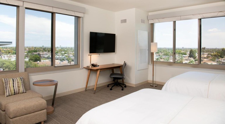 A room with two beds, a flat-screen television and large windows at Element Scottsdale at SkySong