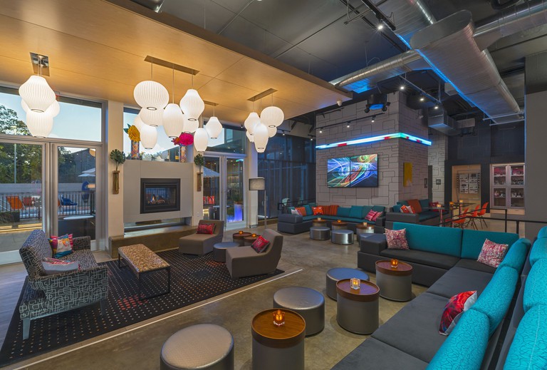 Aloft College Station lobby area with funky lamps, sofas and digital wall art
