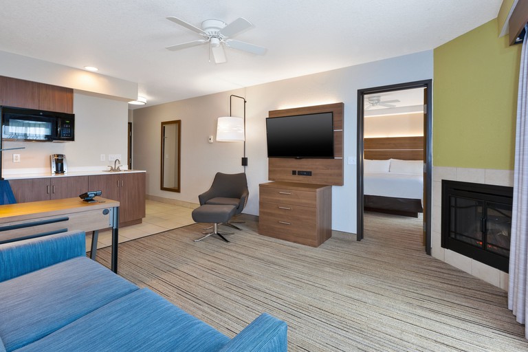Suite at the Holiday Inn Express Hotel and Suites Petoskey, with a blue sofa and brown furniture