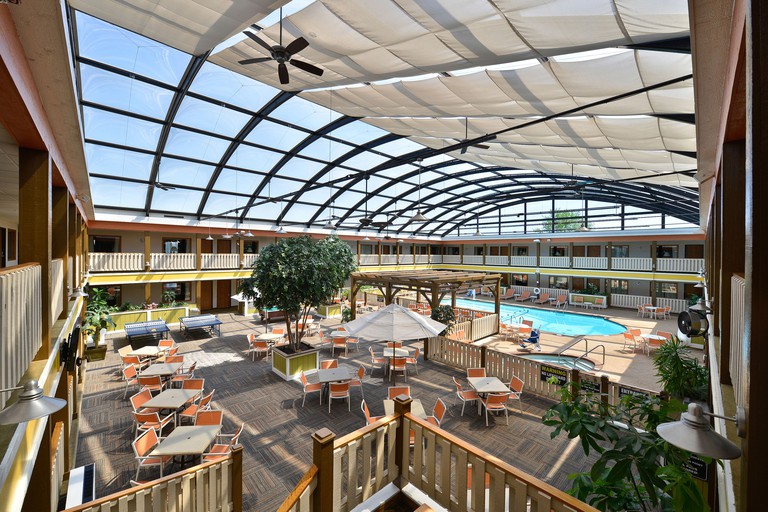 A tropical-inspired atrium with an indoor pool at the Best Western Plus Dubuque Hotel and Conference Center