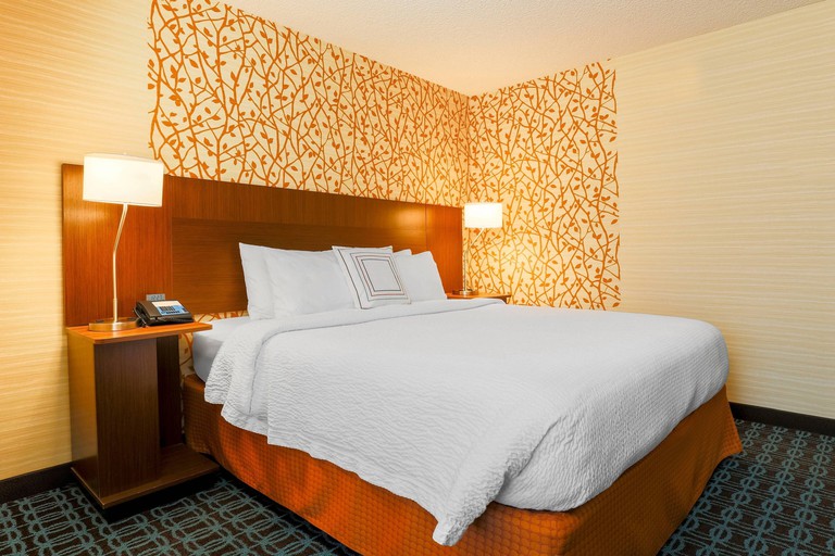King room with rust-and-yellow leaf-patterned wallpaper and dark blue carpeting at Fairfield Inn By Marriott Yuma