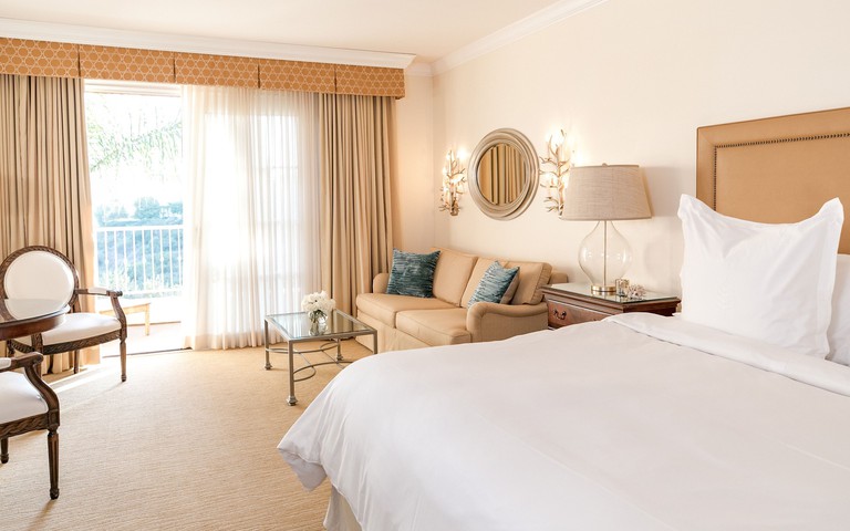 Bedroom at the Four Seasons Residence Club Aviara, North San Diego, with a double bed and a beige sofa