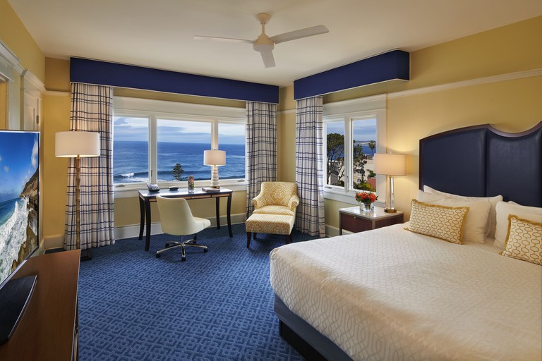 Ocean-view bedroom at the Grande Colonial Hotel, decorated in blue and yellow