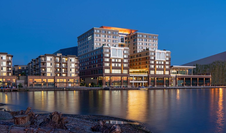 Exterior of Hyatt Regency Lake Washington at Seattle’s Southport with lights on the water