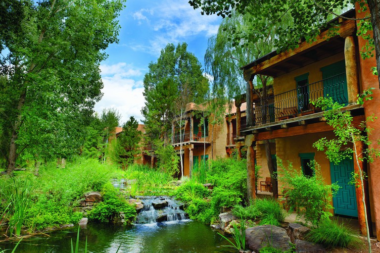El Monte Sagrado Resort & Spa outdoor ponds with lush greenery and balconies