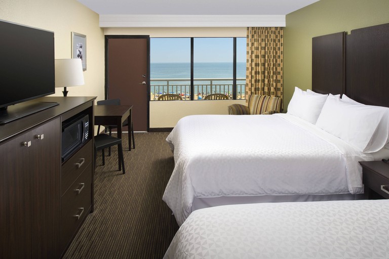 Bedroom with two beds and an ocean-facing balcony at Four Points By Sheraton Virginia Beach Oceanfront