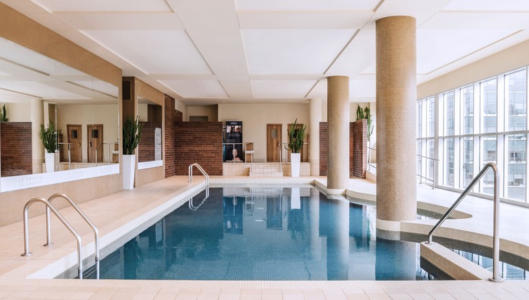 An indoor swimming pool at Hotel Le Crystal with city views