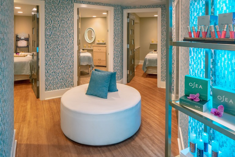 Spa space with center settee and doors to different treatment rooms at Hyatt Centric Key West Resort and Spa