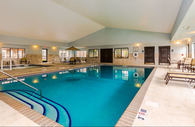 Staybridge Suites Grand Forks indoor pool with seating area and loungers