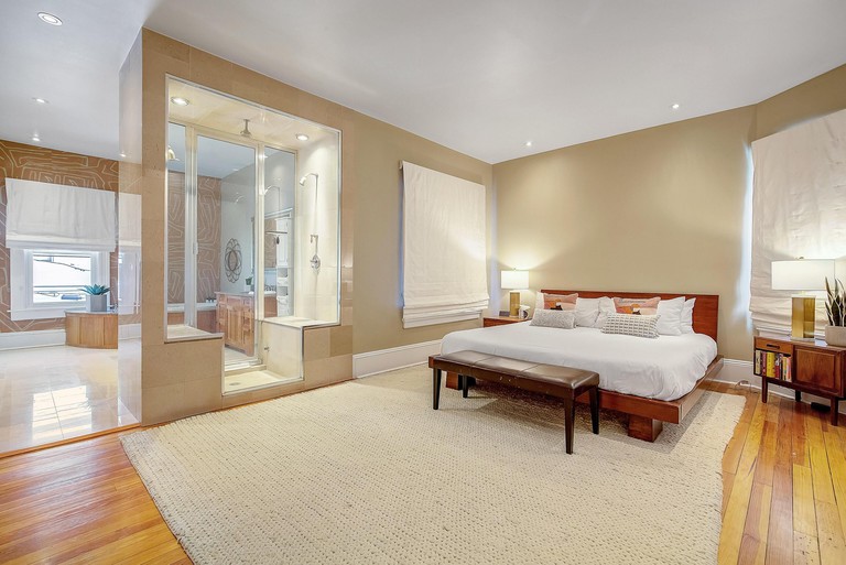 Large bed in a large ensuite room at Stunning Modern Historic Home