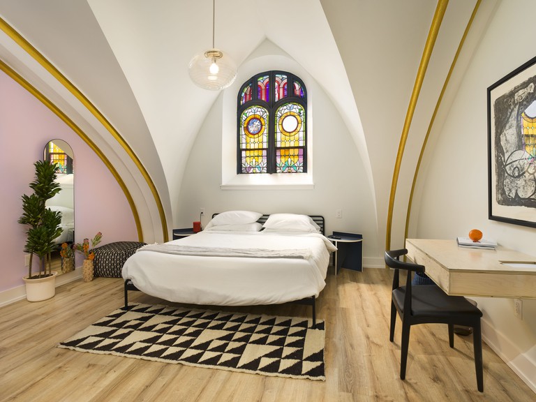 The Deacon double room with stained glass window and desk with wall art
