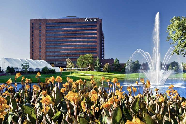 External view of the the Westin Chicago Northwest across a pond with a fountain
