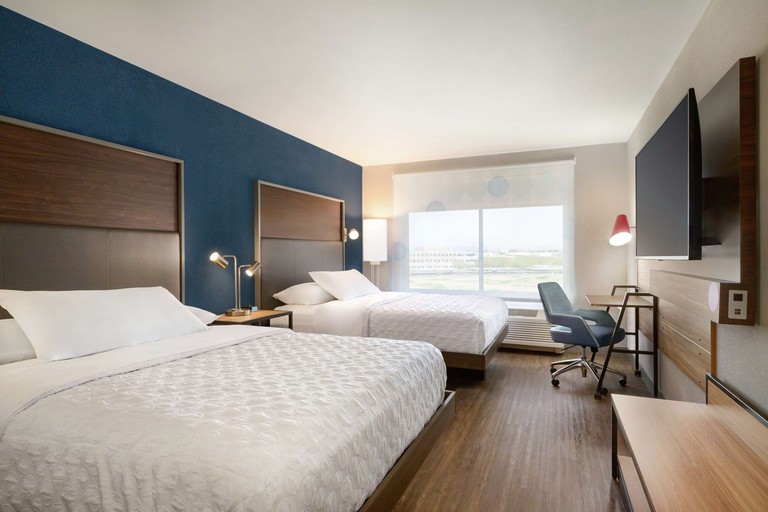 Two double beds with dark-wood headboards in a room at Tru By Hilton Scottsdale Salt River