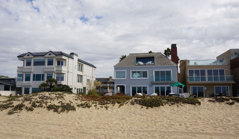 Exterior of Ocean Surf Inn seen from the beach, in Huntington Beach, California