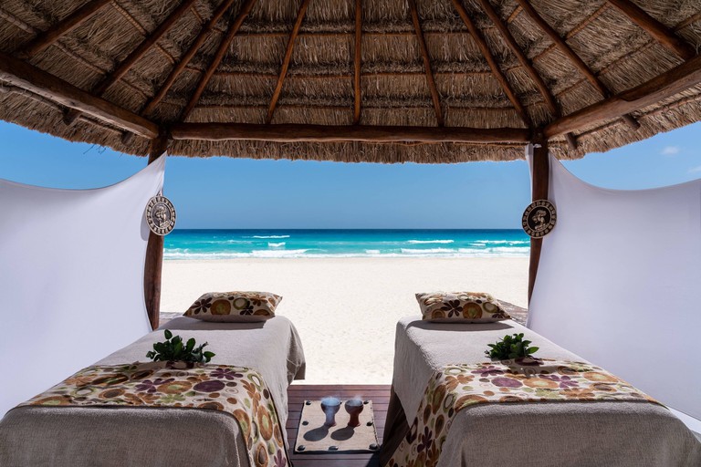 Two massage beds on the beach looking out at the Caribbean sea at The Ritz-Carlton Hotel