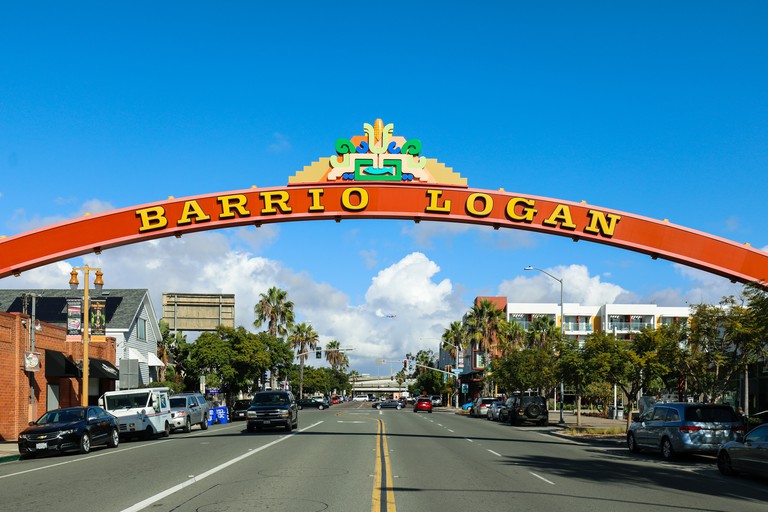 Sign that marks the entrance to Barrio Logan above a street in San Diego