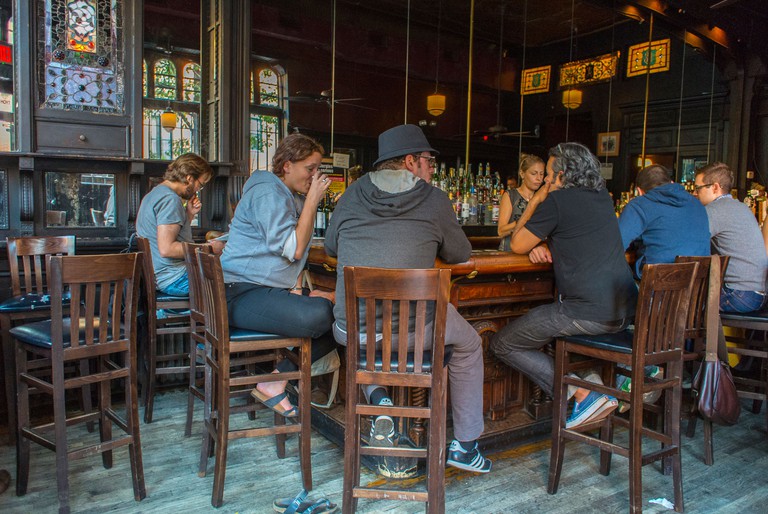 People drinking at the 19th-century bar inside Brooklyn Inn